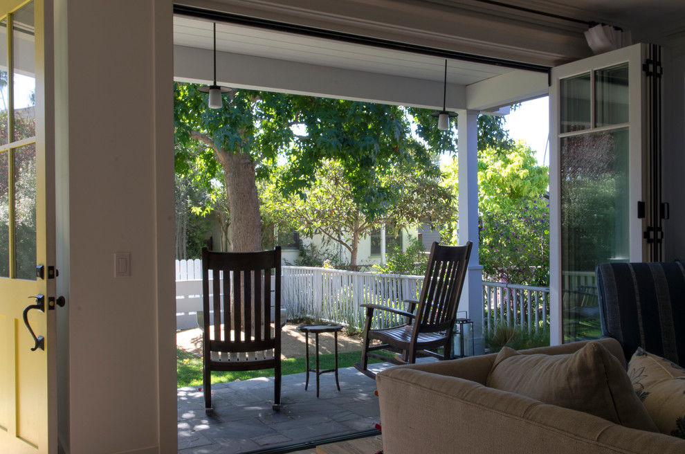 Design ideas for a medium sized contemporary front veranda in Los Angeles with natural stone paving and a roof extension.