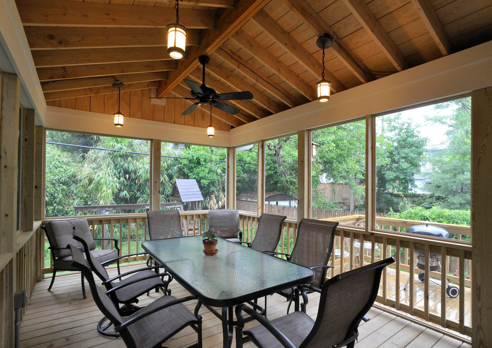 This is an example of a mid-sized contemporary back porch design in Baltimore with decking and a roof extension.