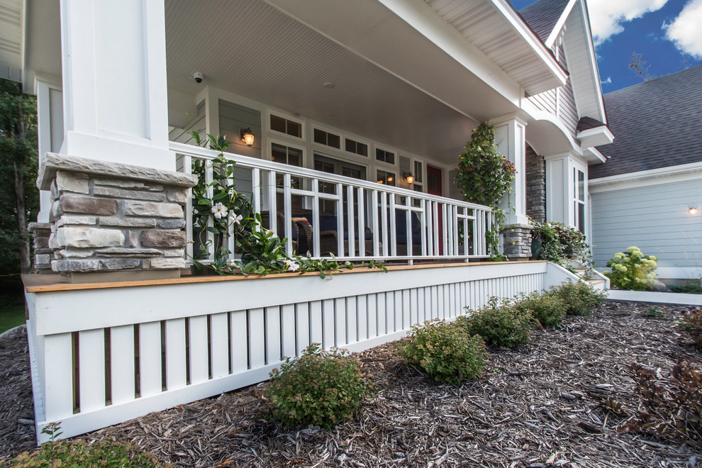 Mid-sized arts and crafts front porch idea in Minneapolis with decking and a roof extension