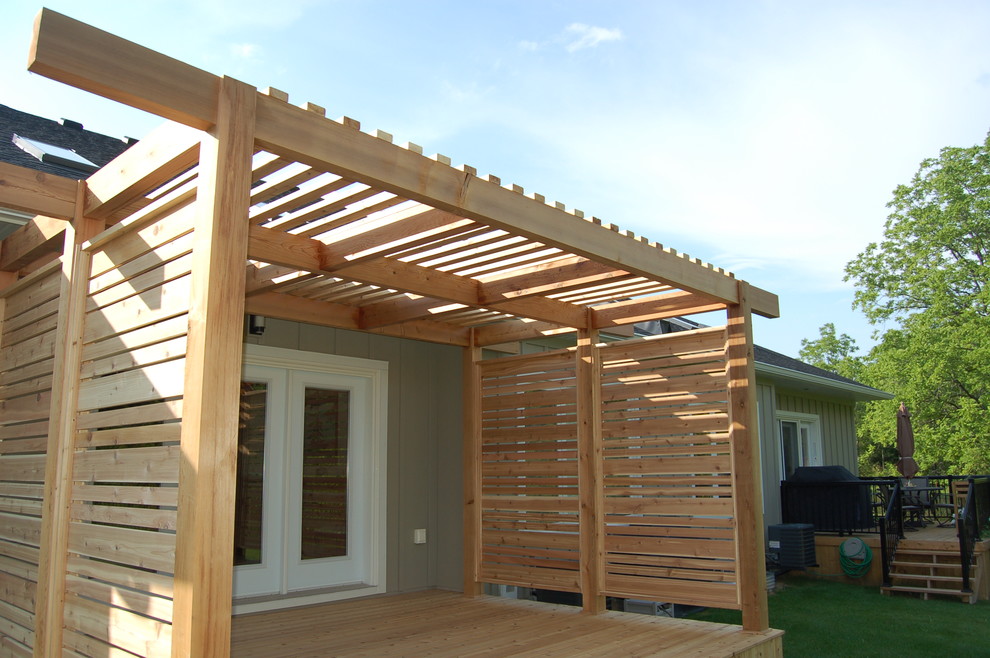 Cette photo montre un porche d'entrée de maison arrière asiatique de taille moyenne avec une terrasse en bois et une pergola.