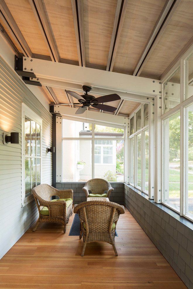 Classic screened-in front porch idea in Minneapolis with a roof extension