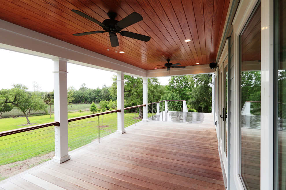This is an example of a traditional porch design in Charleston with decking.