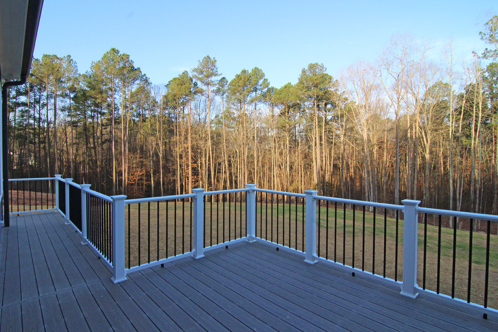 Huge elegant screened-in back porch photo in Raleigh with decking and a roof extension