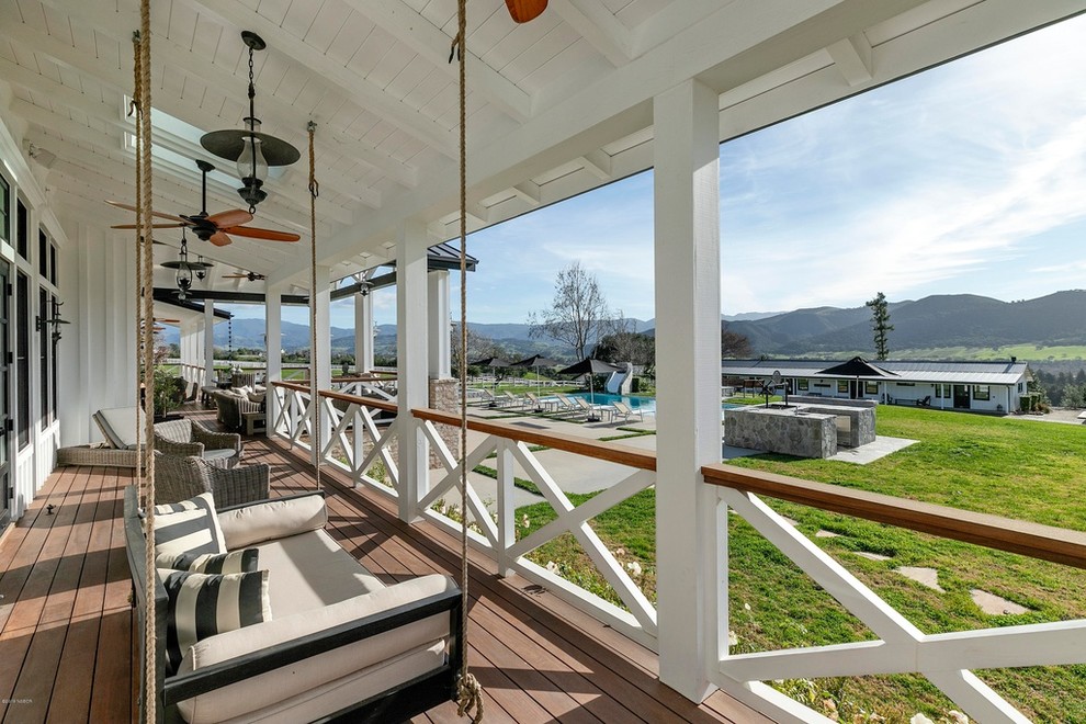 Inspiration for a large rural front veranda in Orange County with decking and a roof extension.