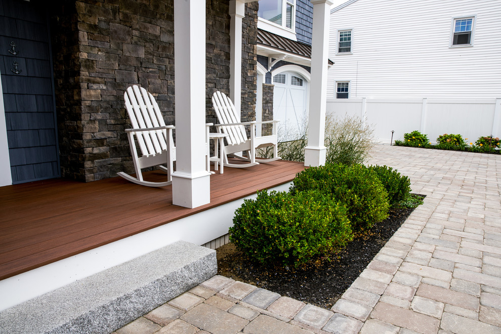 Inspiration for a mid-sized coastal front porch remodel in Boston with a roof extension and decking