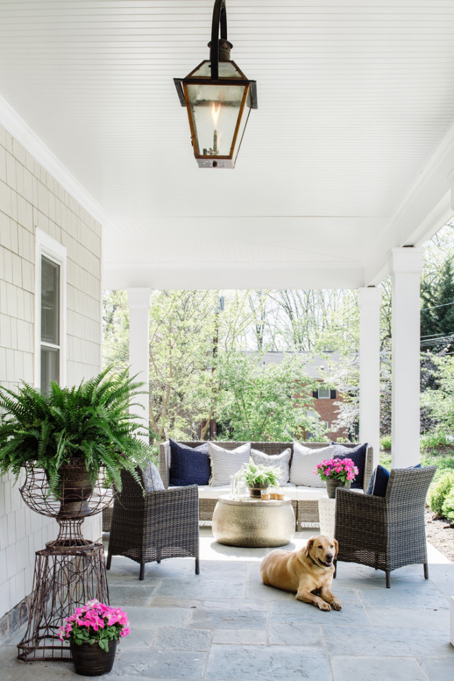 Design ideas for a medium sized farmhouse side veranda in DC Metro with natural stone paving and a roof extension.