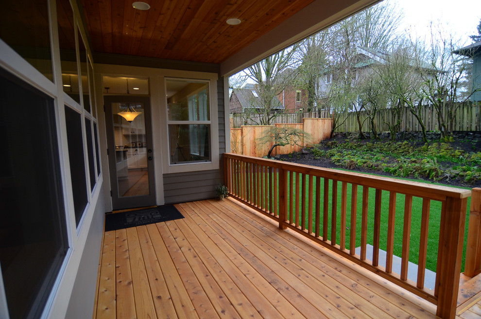 Mid-sized transitional back porch photo in Portland with decking and a roof extension