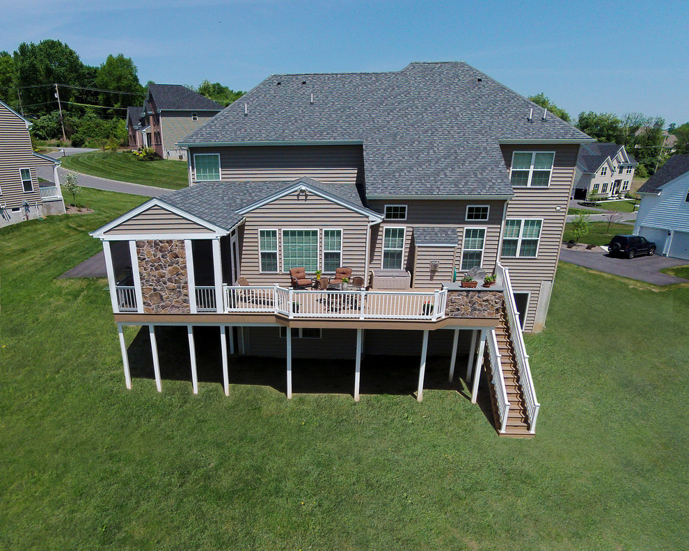 This is an example of a mid-sized traditional porch design in Philadelphia with decking and a roof extension.