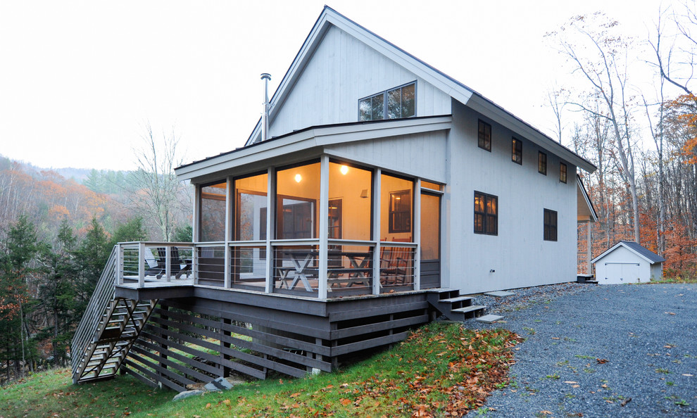 This is an example of a mid-sized modern porch design in Boston with decking and a roof extension.
