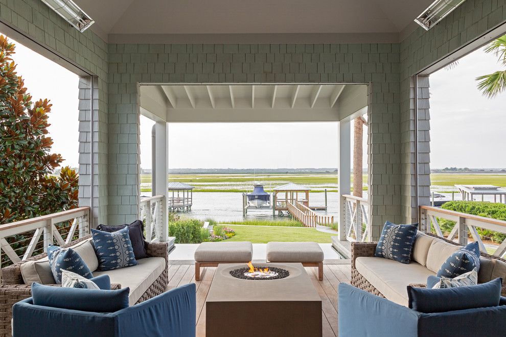Beach style porch photo in Charleston with decking and a roof extension