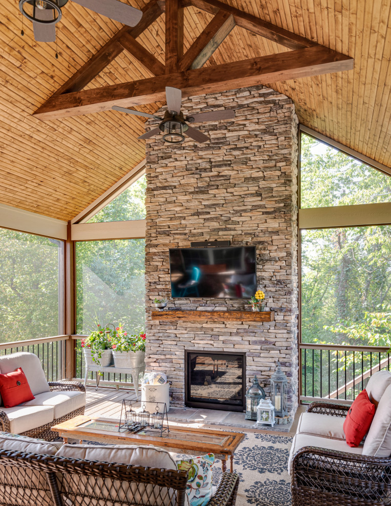 Design ideas for a large back veranda in Nashville with a fireplace, decking and a roof extension.