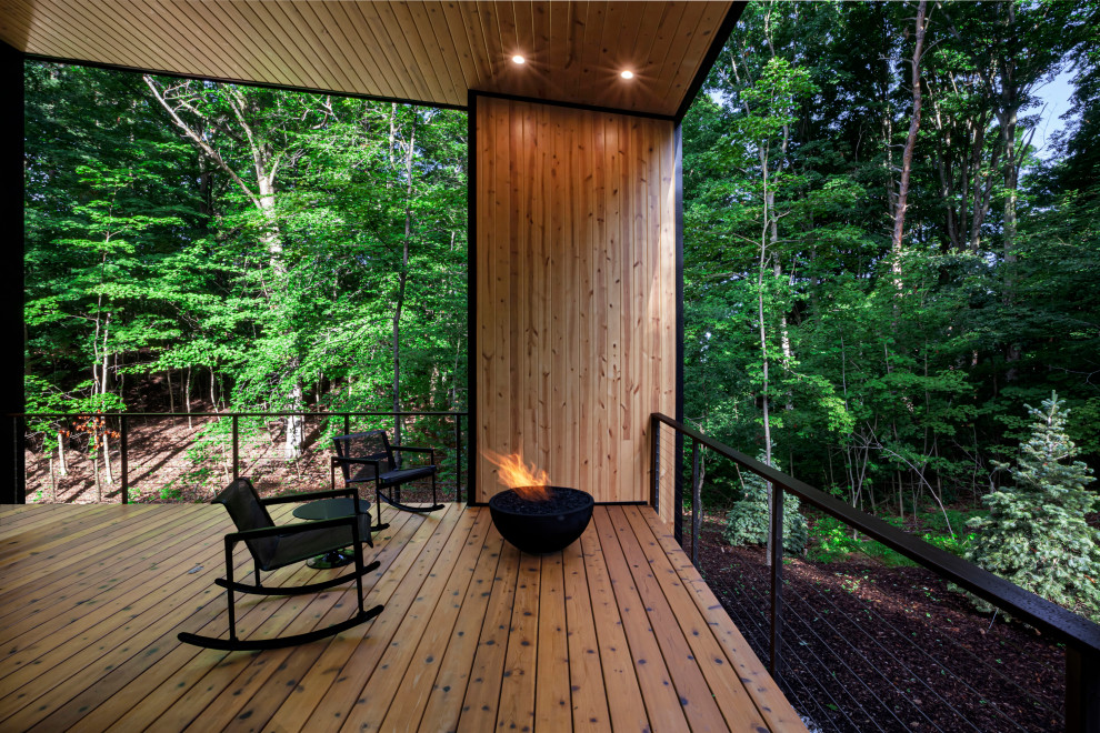 Medium sized midcentury back veranda in Grand Rapids with a fire feature, decking and a roof extension.