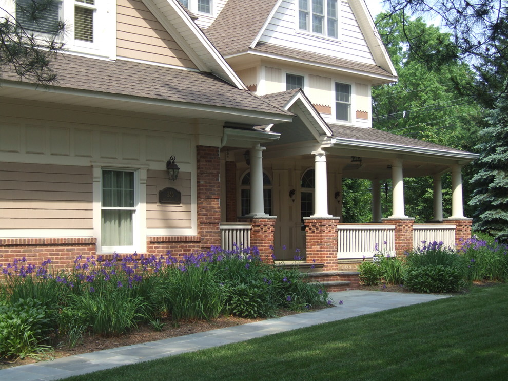 Idéer för en stor klassisk veranda framför huset, med naturstensplattor och takförlängning