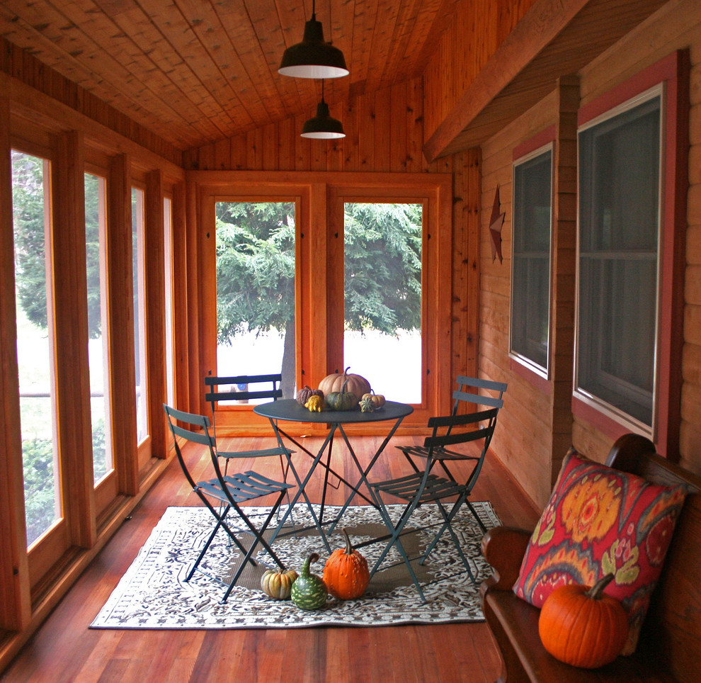 This is an example of a traditional porch design in Burlington with decking and a roof extension.
