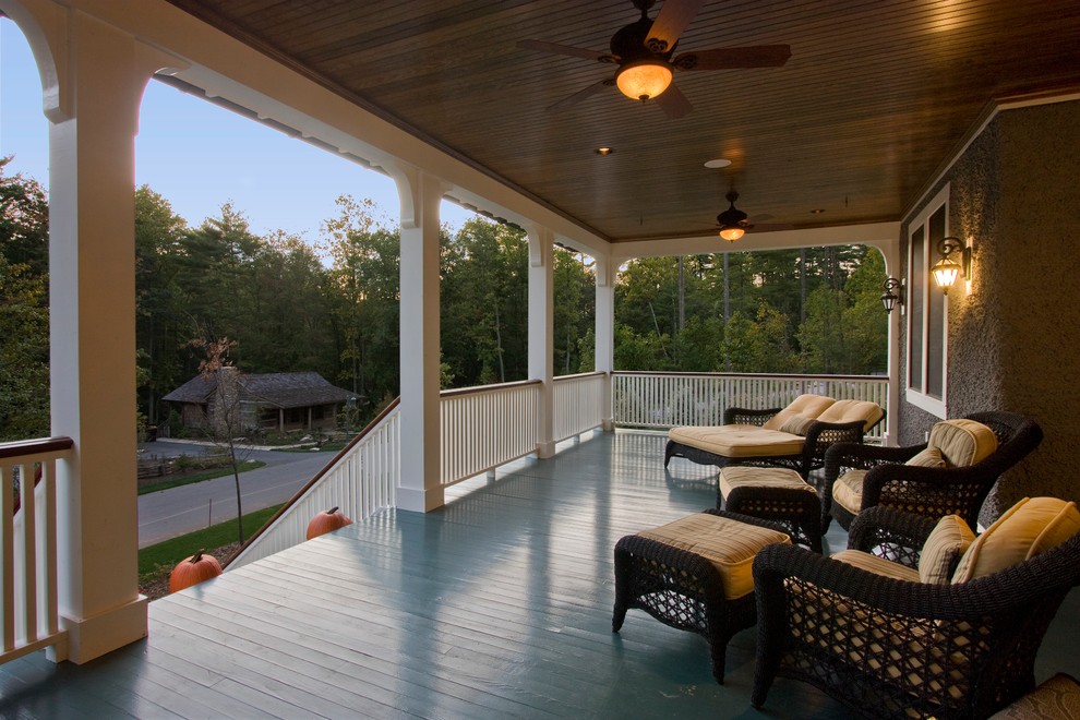 Inspiration for a large timeless front porch remodel in Other with decking and a roof extension