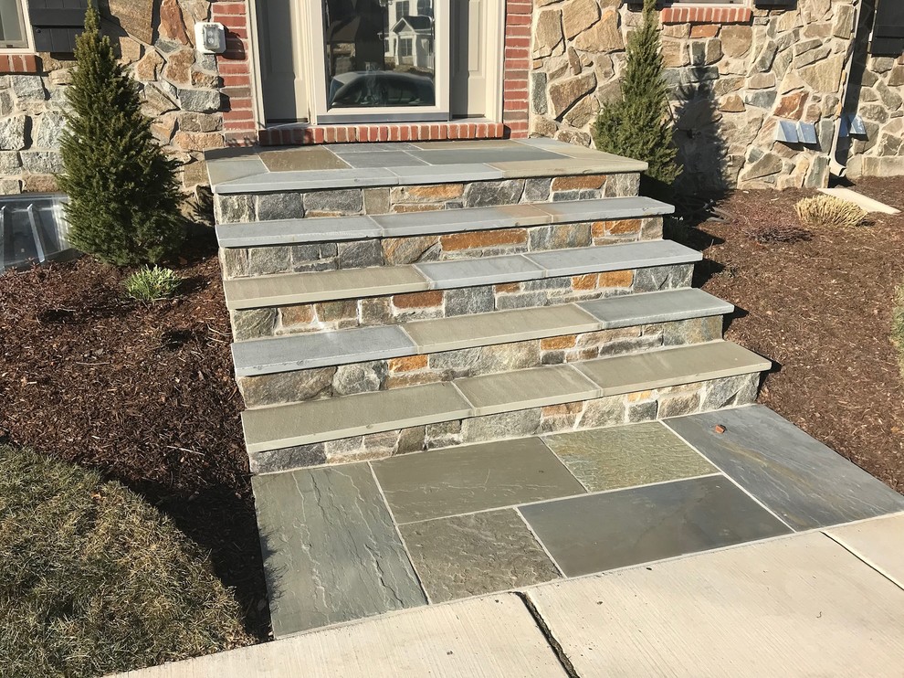 Inspiration for a timeless stone front porch remodel in DC Metro