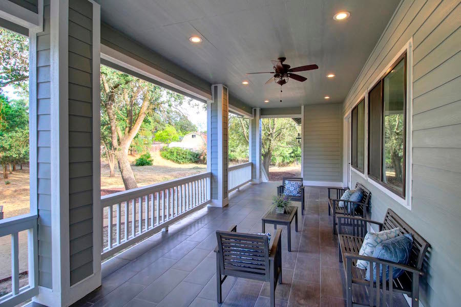 This is an example of a large traditional tile back porch design in San Francisco with a roof extension.