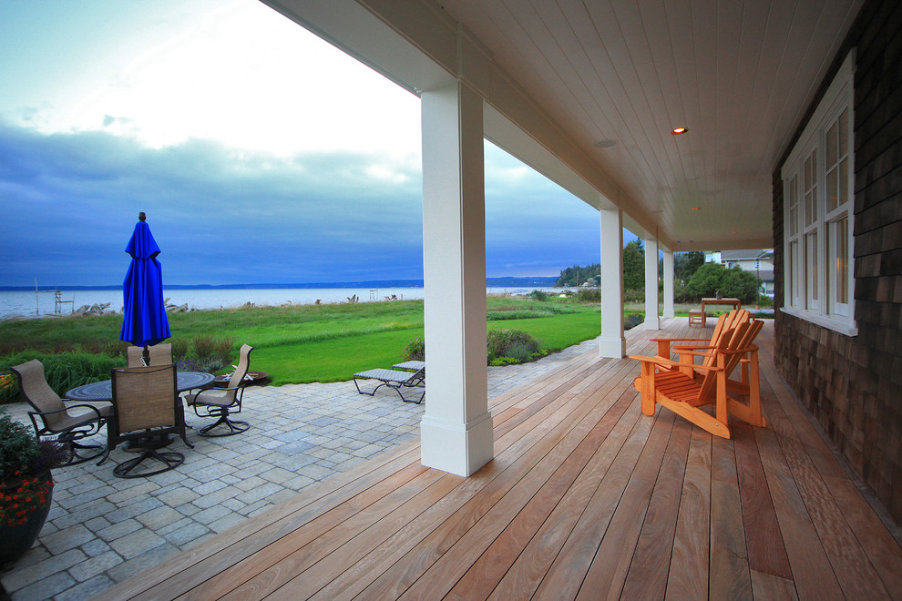 This is an example of a mid-sized coastal back porch design in Seattle with decking and a roof extension.