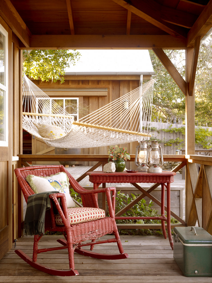 This is an example of a rustic front porch design in San Francisco with decking and a roof extension.