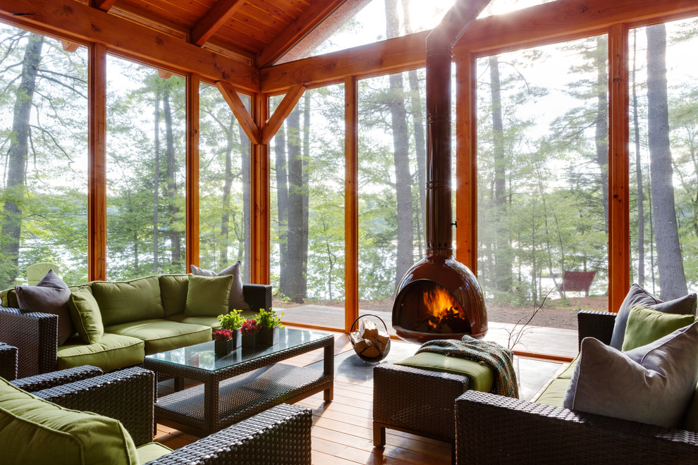 This is an example of a rustic back screened veranda in Boston.