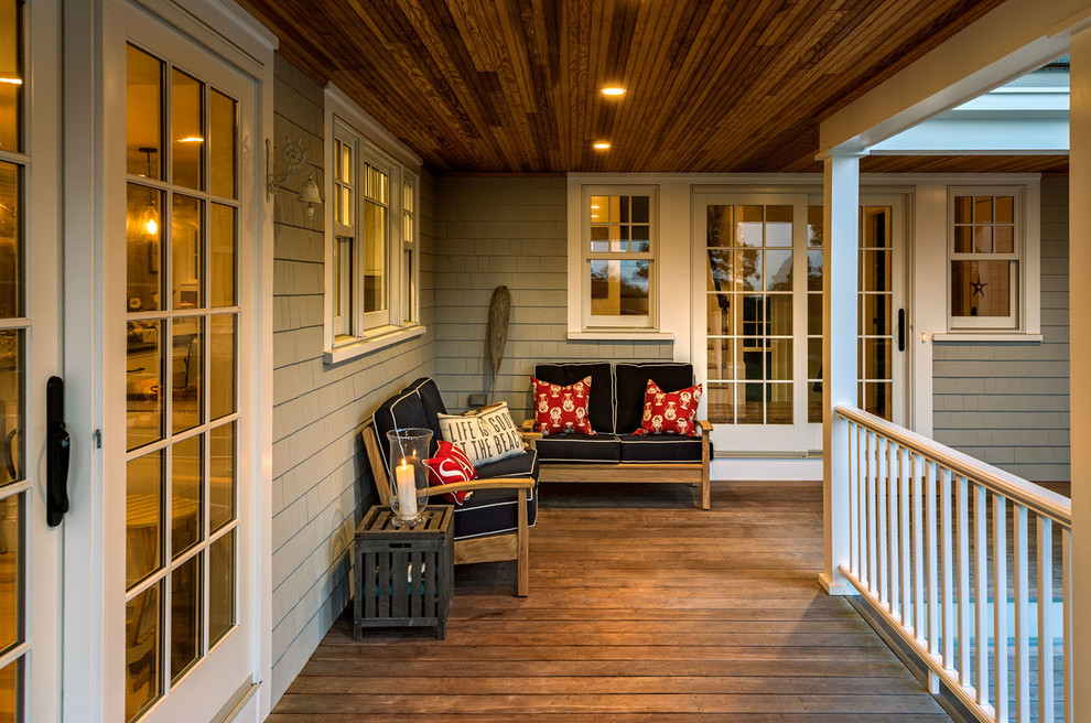 Inspiration for a mid-sized coastal front porch remodel in Boston with decking and a roof extension