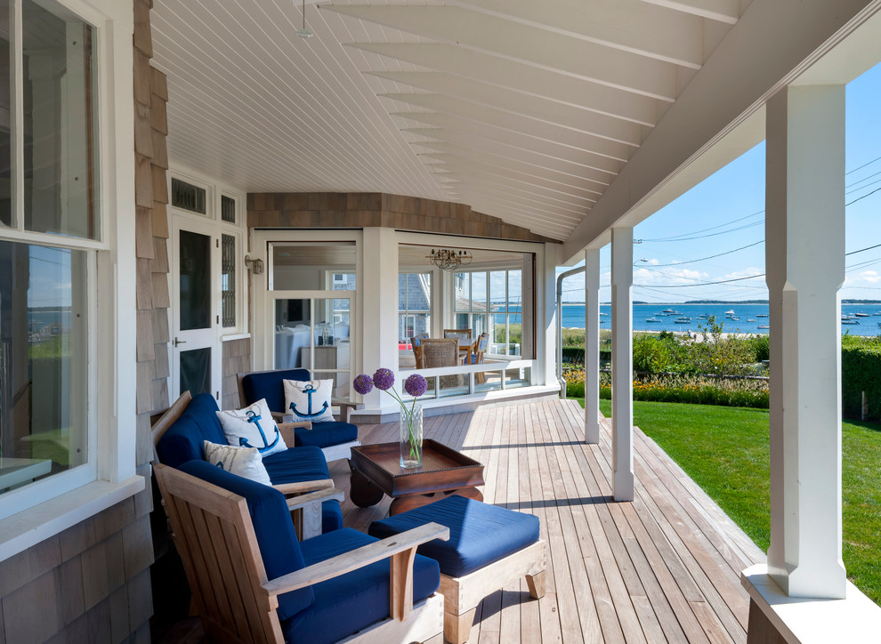 This is an example of a coastal front porch design in Boston.