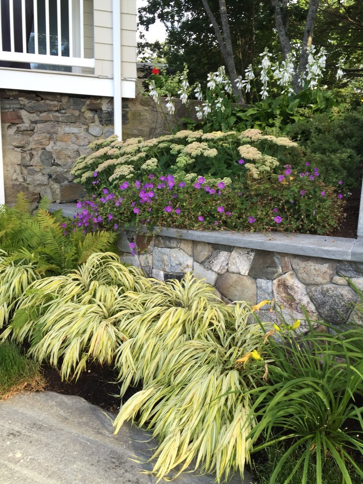 Photo of a large traditional backyard concrete paver landscaping in Portland Maine.