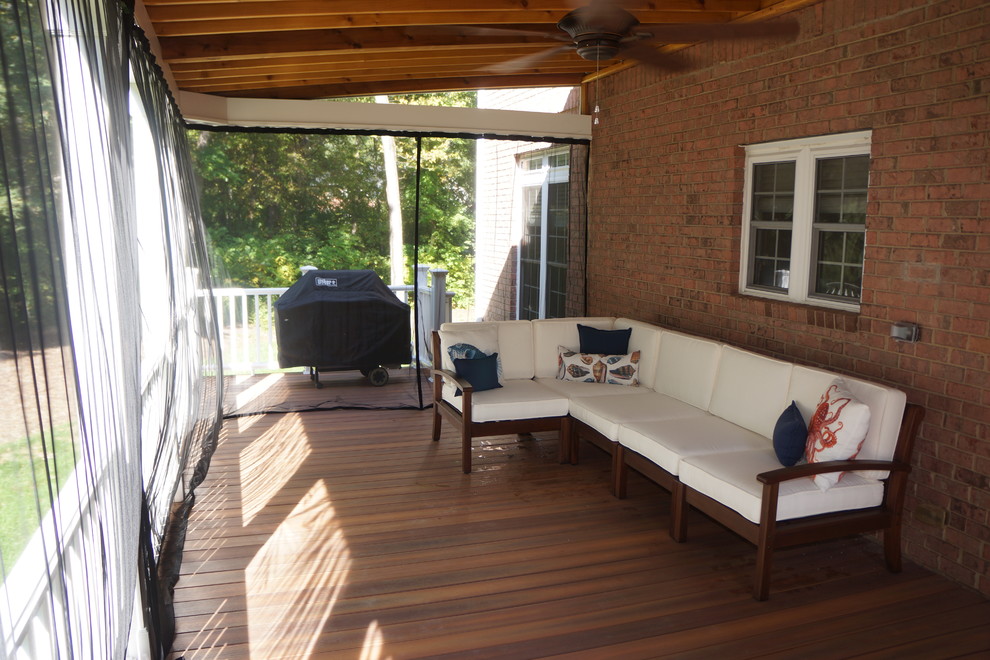 Large elegant back porch photo in Charlotte with decking and a pergola