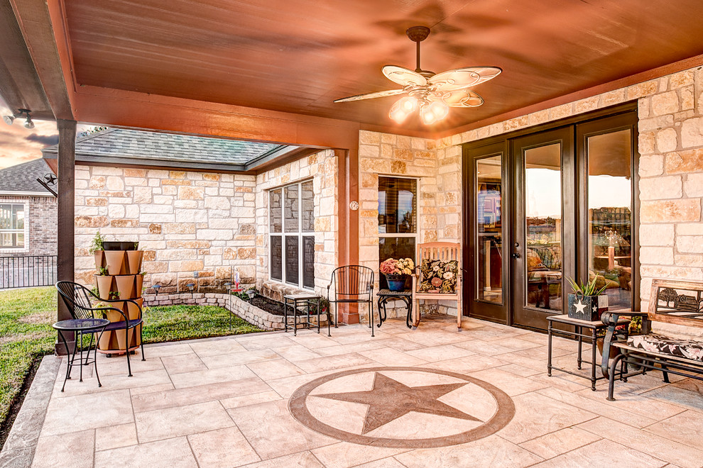 Inspiration for a mid-sized cottage stamped concrete porch remodel in Houston with a roof extension