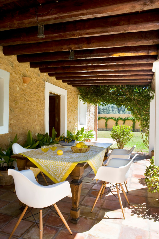 Diseño de terraza mediterránea, de tamaño medio, en patio trasero y anexo de casas, con jardín de macetas y suelo de baldosas