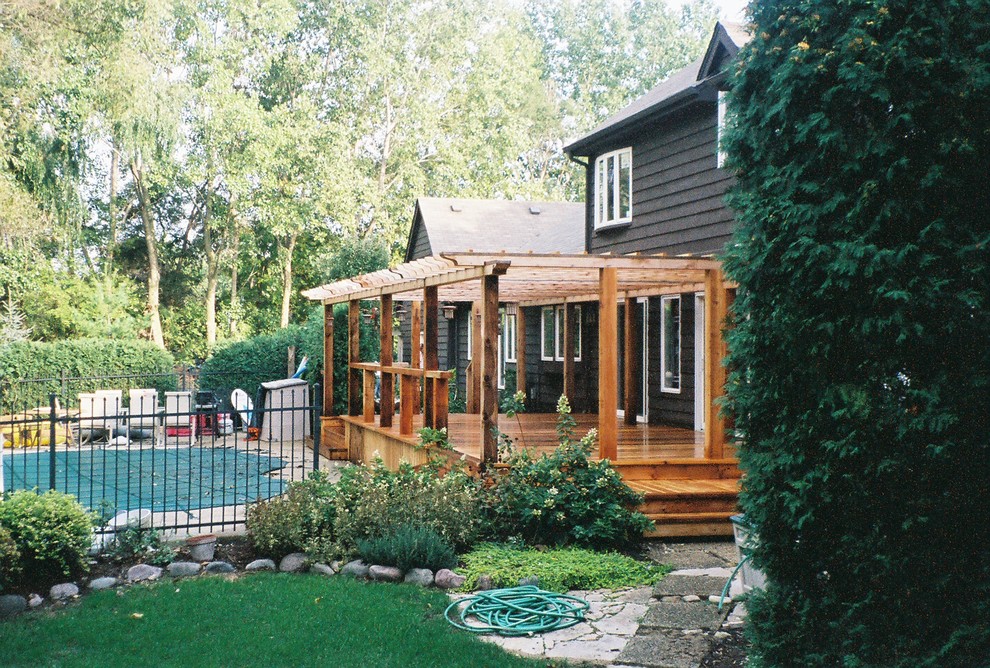 Inspiration for an expansive rustic back veranda in Chicago with decking and a pergola.