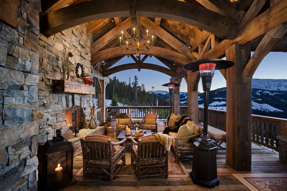 Rustic veranda in Other with a fire feature.