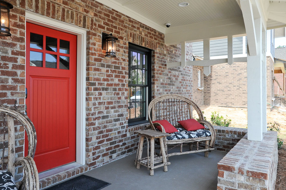 Inspiration pour un porche d'entrée de maison avant rustique de taille moyenne avec une dalle de béton et une extension de toiture.