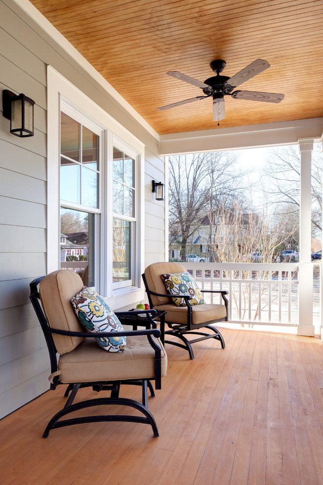 Cette photo montre un porche d'entrée de maison avant chic de taille moyenne avec une terrasse en bois et une extension de toiture.
