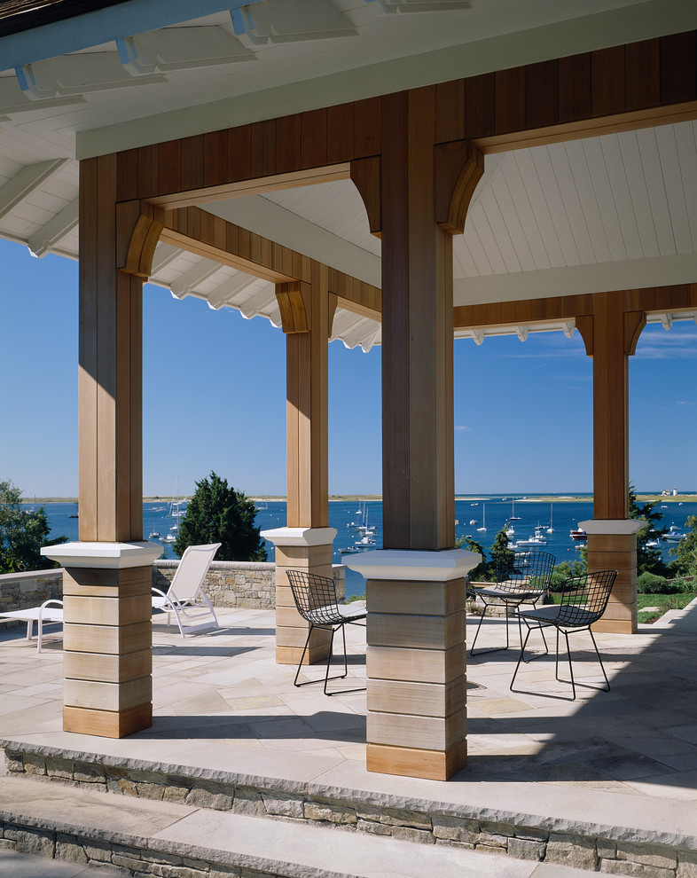Design ideas for a traditional veranda in Boston with a roof extension.