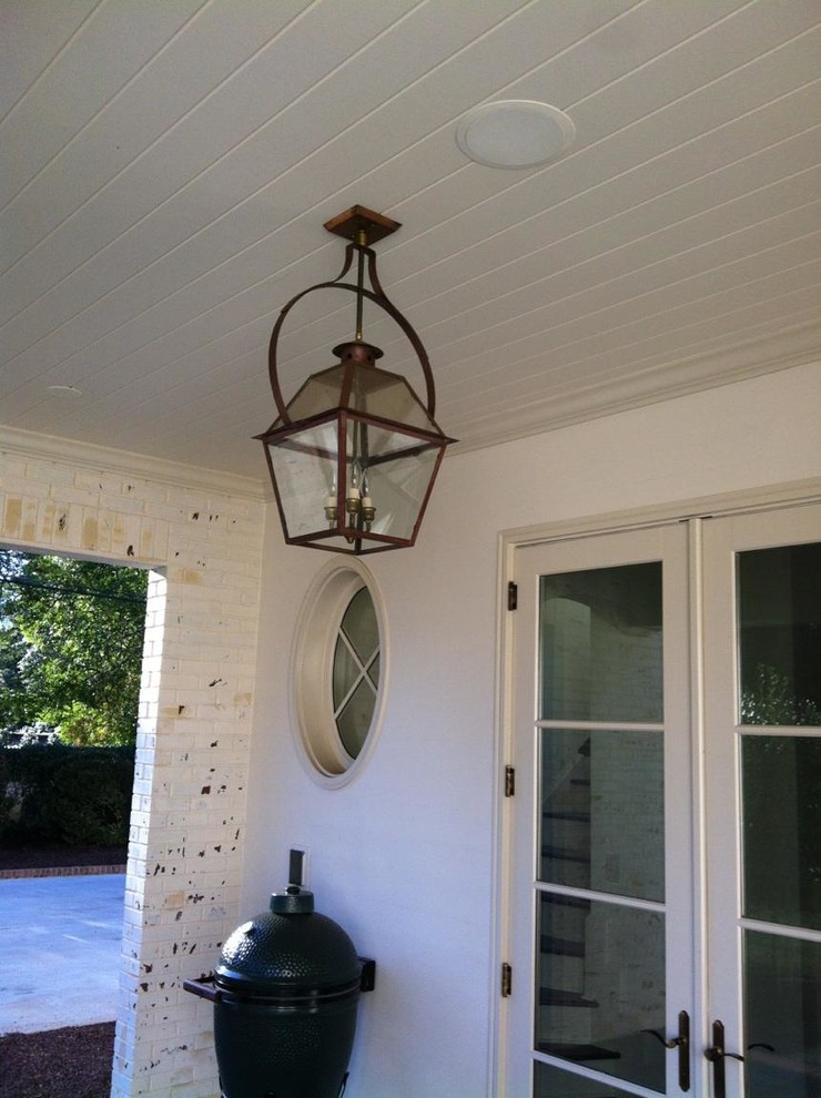 This is an example of a mid-sized traditional back porch design in Charlotte.