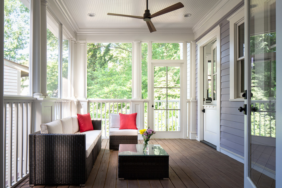 Huge transitional screened-in back porch photo in Atlanta with decking and a roof extension