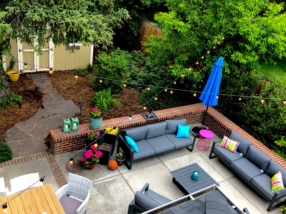 Inspiration for a medium sized bohemian back patio in Denver with concrete slabs.
