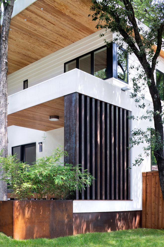 Inspiration for a large modern back veranda in Austin with a roof extension and decking.