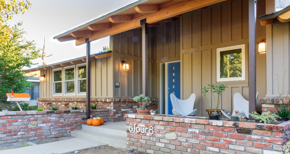 Inspiration pour un porche d'entrée de maison avant design de taille moyenne avec une dalle de béton et une extension de toiture.