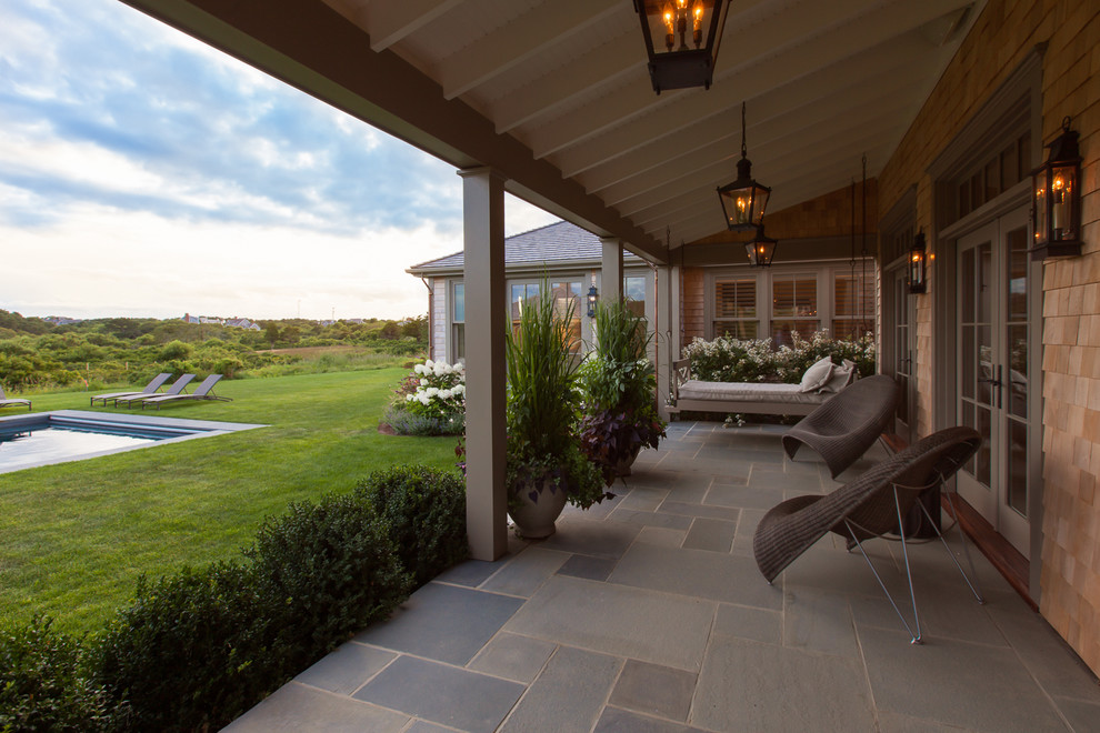 Inspiration for a large coastal veranda in Boston with feature lighting.
