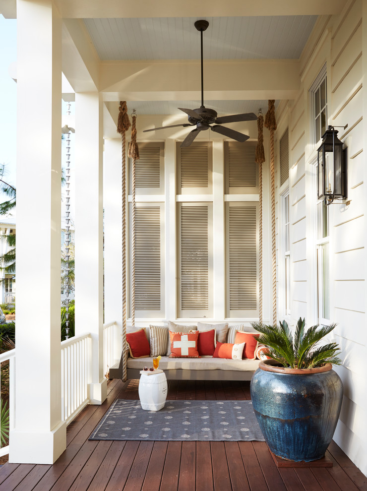 This is an example of a coastal front porch design with decking and a roof extension.