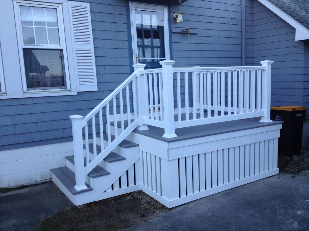 This is an example of a small craftsman back porch design in Portland Maine with decking.