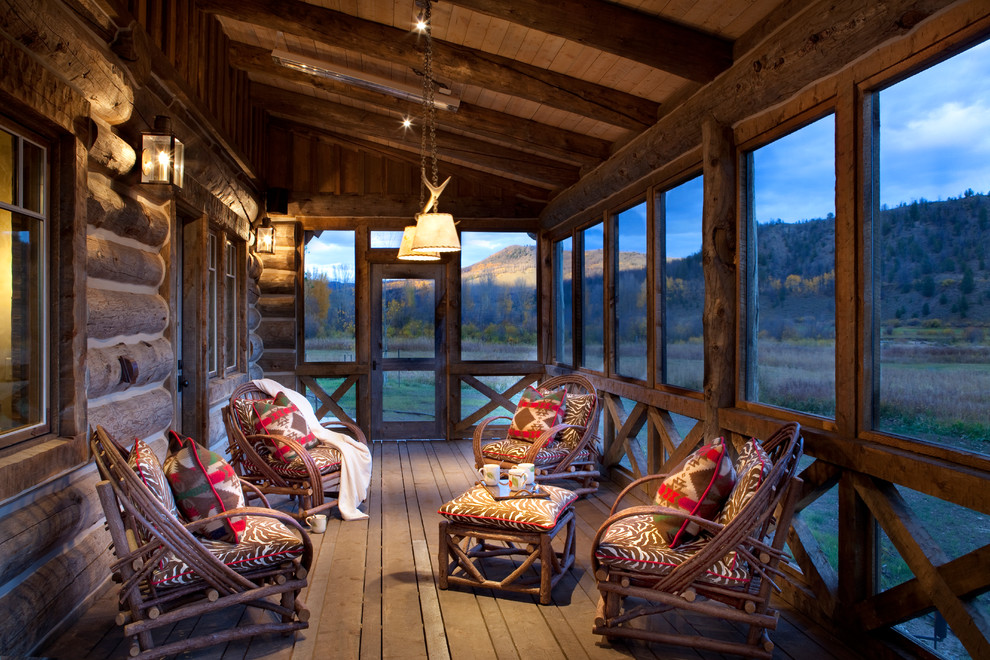 Inspiration for a medium sized rustic back screened veranda in Denver with decking and a roof extension.