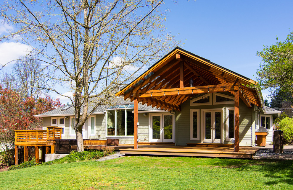 Immagine di un ampio portico minimal dietro casa con pedane, un tetto a sbalzo e parapetto in legno