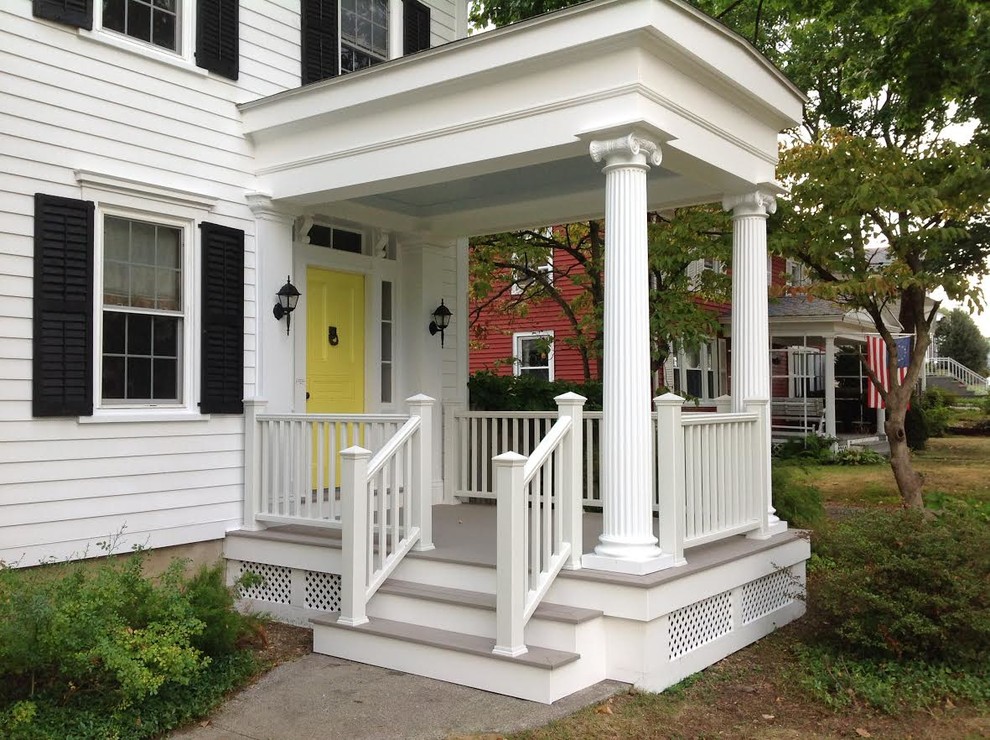Mid-sized classic front porch idea in New York with decking and a roof extension