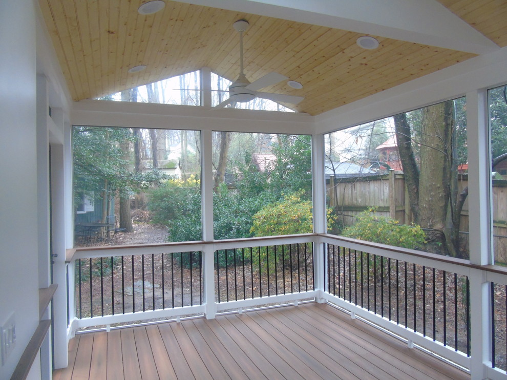 Screened-in back porch photo in DC Metro with decking and a roof extension