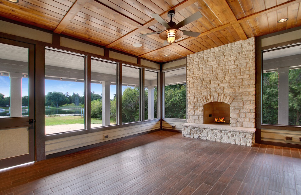 Inspiration for a large farmhouse back veranda in Chicago with a fire feature, decking and a roof extension.