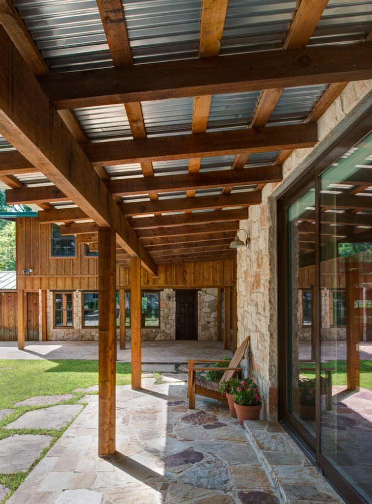 This is an example of a contemporary veranda in Austin with a roof extension.