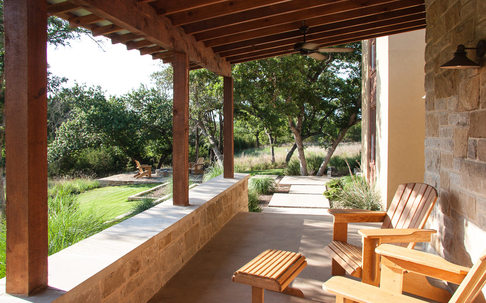 This is an example of a mid-sized contemporary front porch design in Austin with a fire pit.